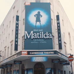 Outside of the Cambridge Theatre showing the Matilda sign