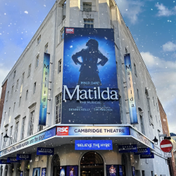 Outside of the Cambridge Theatre showing the Matilda sign in the snow!